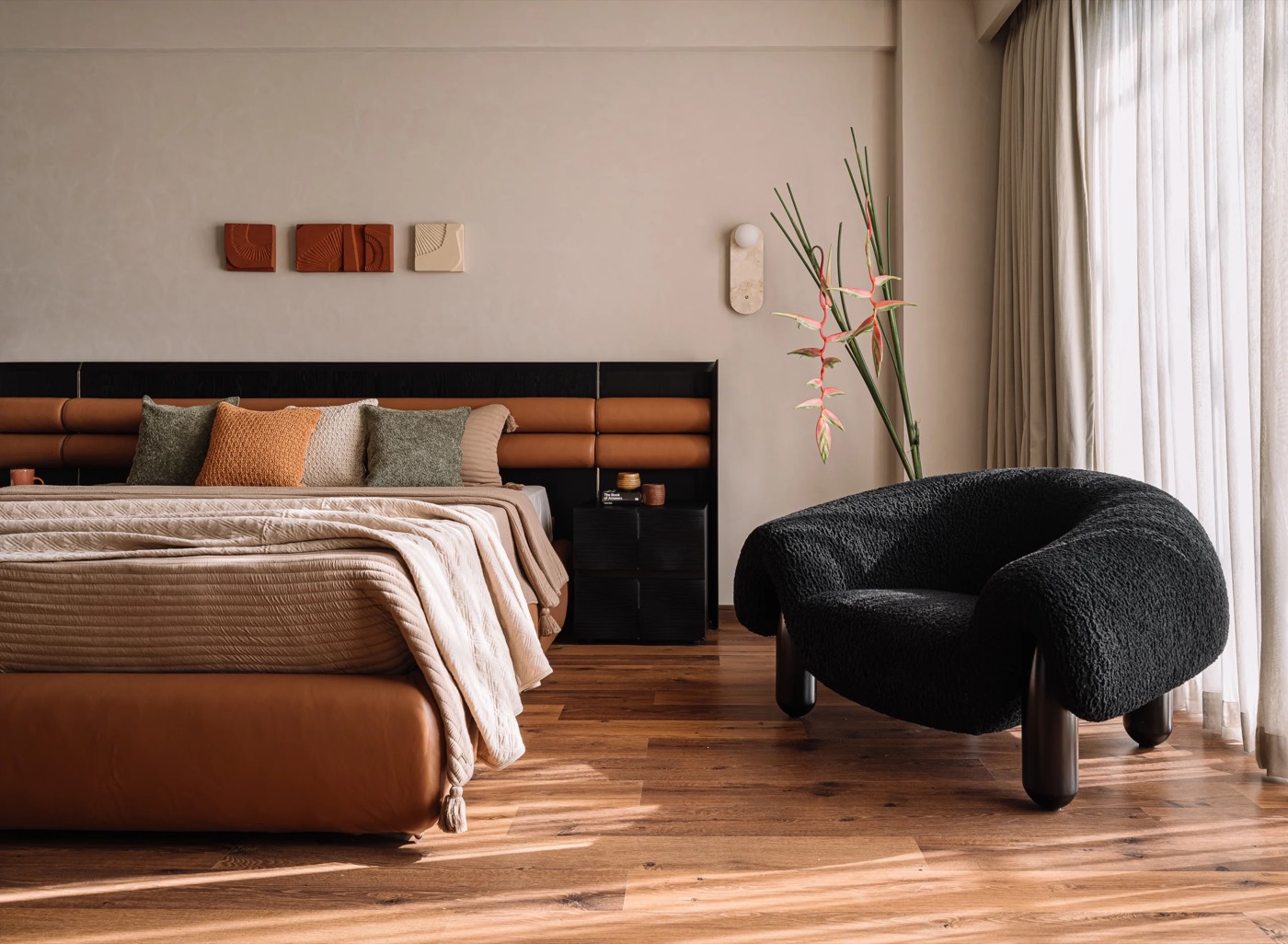 Finished bedroom at Kent Eco Sanctum with laminated wooden flooring and leather headboard